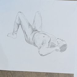A pencil sketch of the same man lying down with his head towards you and both knees up