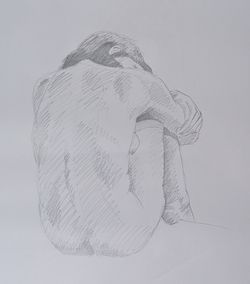 A pencil sketch of a woman sitting with her arms around her legs and her head resting on her arms