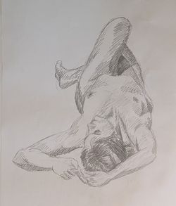 A pencil sketch of a woman lying on her back, with her head towards us