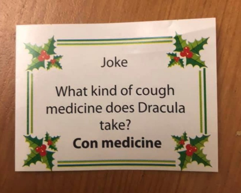An insert from a Christmas cracker, bearing the 'joke': What kind of cough medicine does Dracula take? Con medicine.
